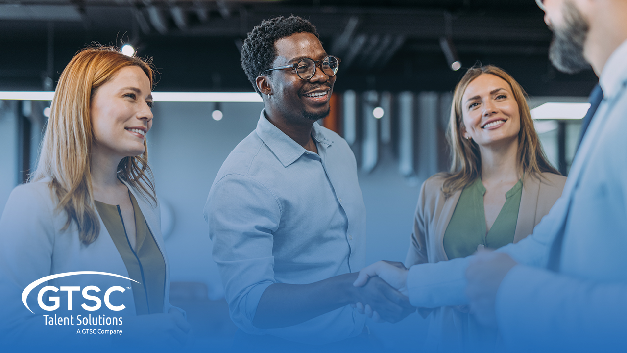 Professionals shaking hands in office