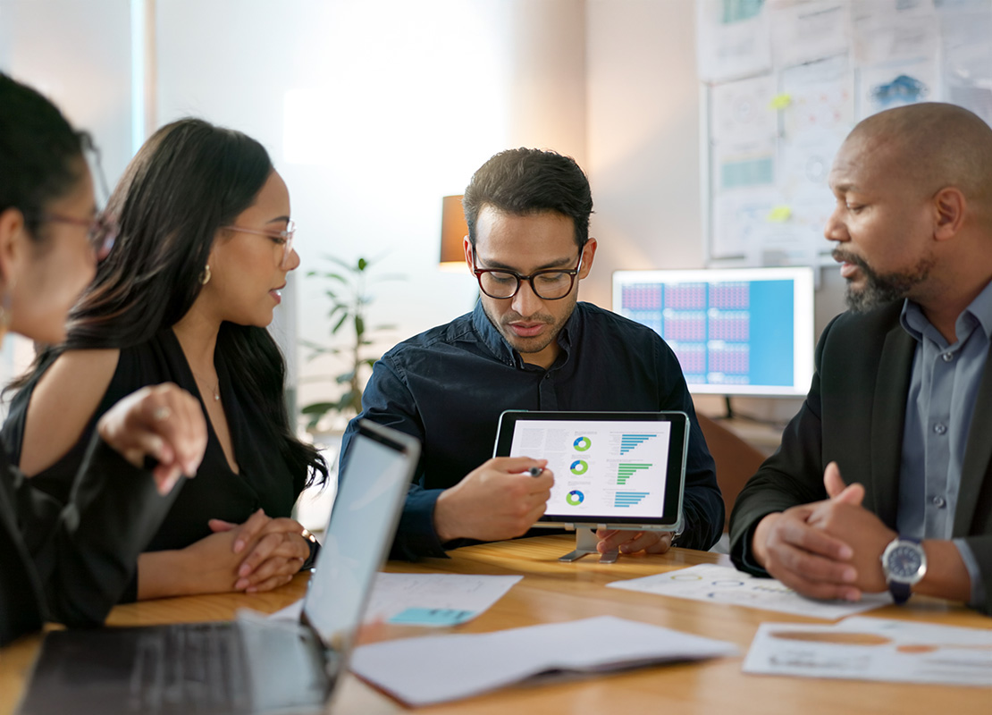 Business team in office with presentation on tablet